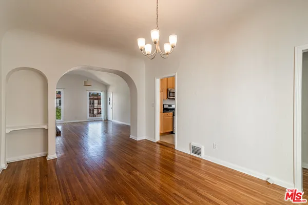 a view of a room with wooden floor
