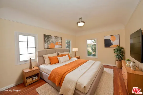 a bedroom with a bed and a flat screen tv