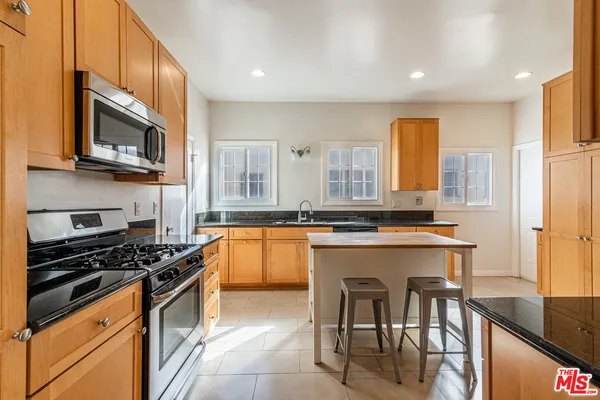 a kitchen with stainless steel appliances a stove cabinets and a microwave