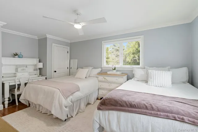 a bedroom with two beds and a chandelier