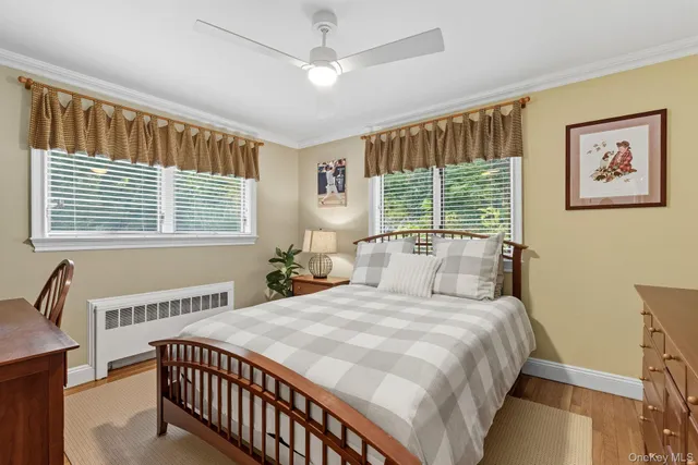 a bedroom with a large bed and a window