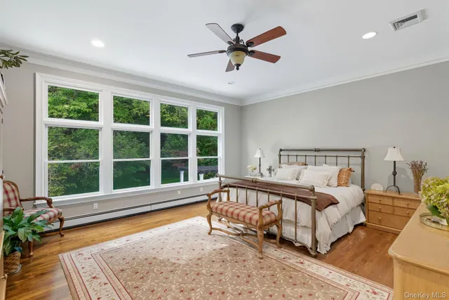 a large bedroom with a bed and a large window