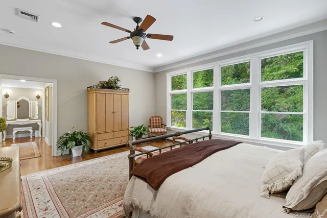 a large bedroom with a large bed and a large window