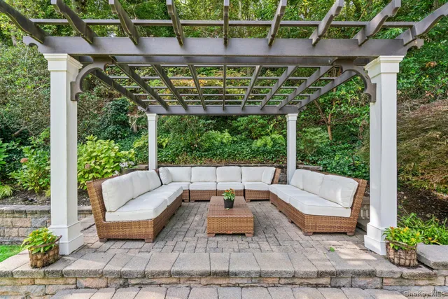 a building outdoor space with patio furniture and potted plants