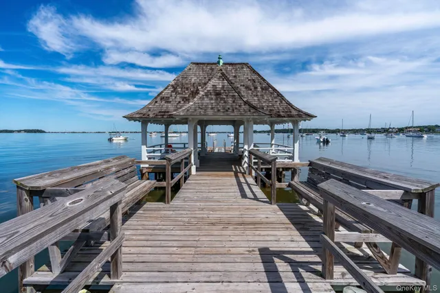 a view of a roof deck with chair and wooden floor