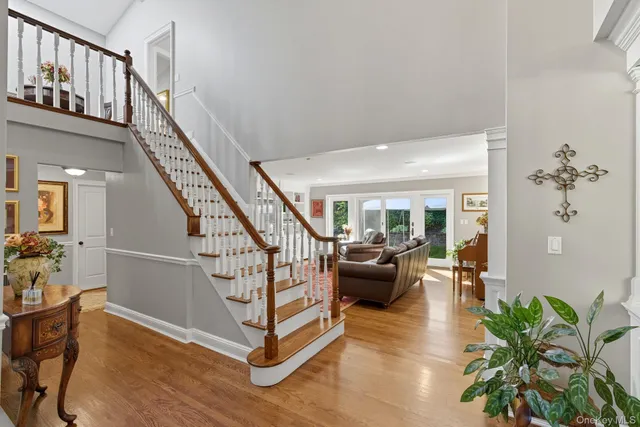 a view of entryway livingroom and hall with wooden floor