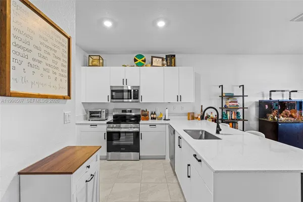 a kitchen with a stove a sink and a refrigerator