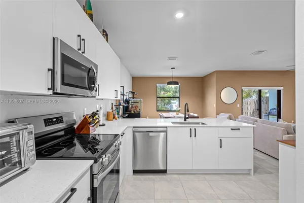 a kitchen with a sink stove and microwave