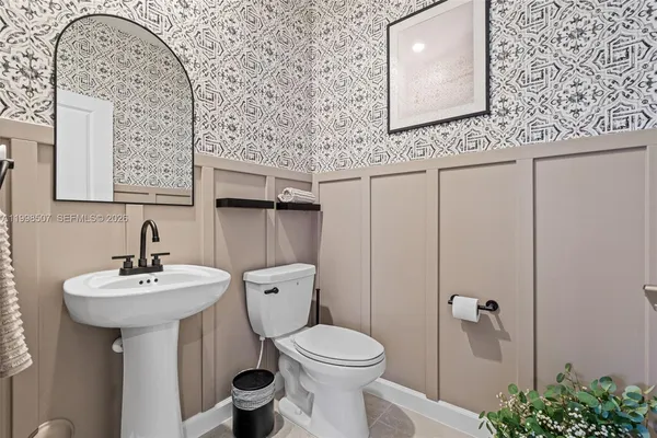 a bathroom with a sink mirror toilet and vanity