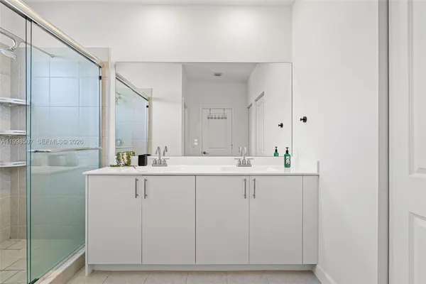 a bathroom with double sink and mirror