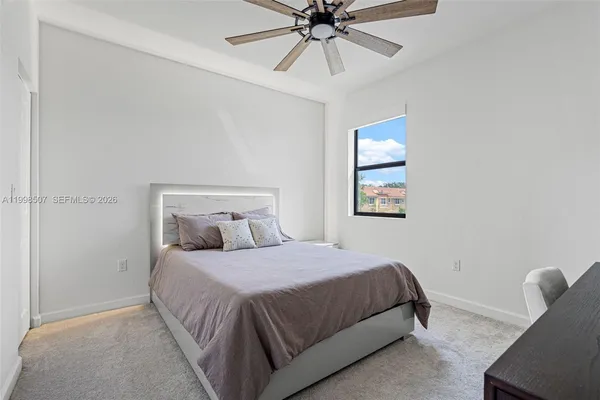 a bedroom with a bed and window