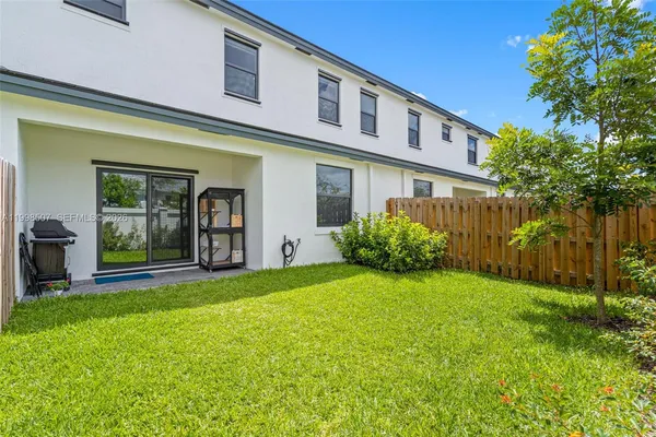 a view of backyard with garden and deck