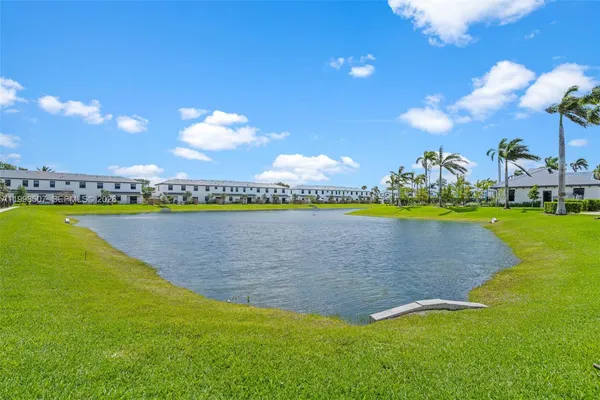 a view of a house with swimming pool and sitting area