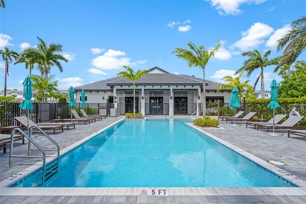 a view of swimming pool with outdoor seating and trees