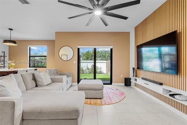 a living room with furniture and a flat screen tv