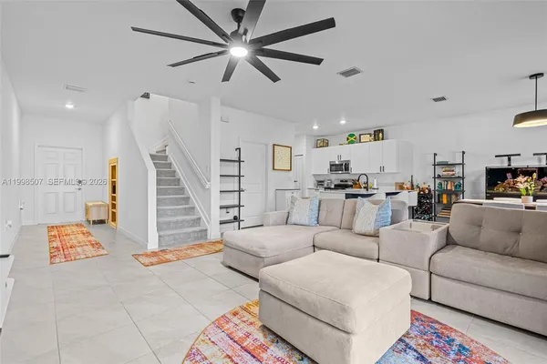 a living room with furniture and wooden floor