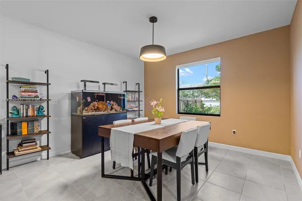 a view of a dining room with furniture and chandelier
