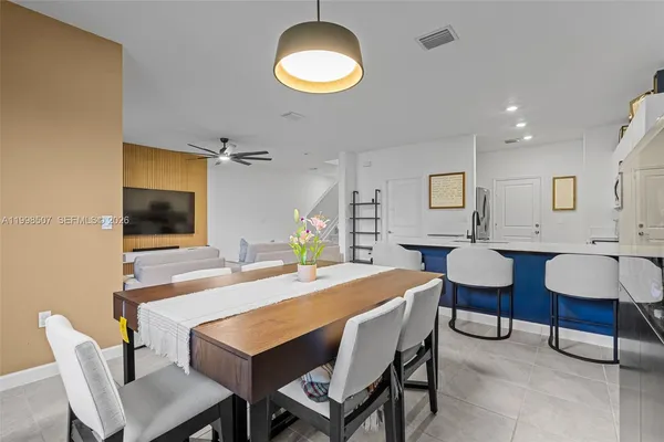 a dining room with a table and chairs