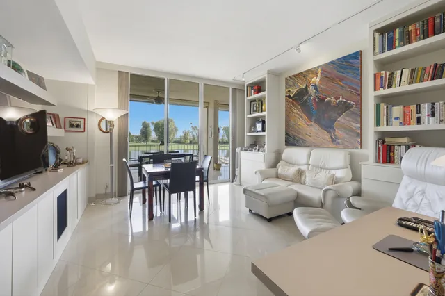 a dining room with furniture and a flat screen tv