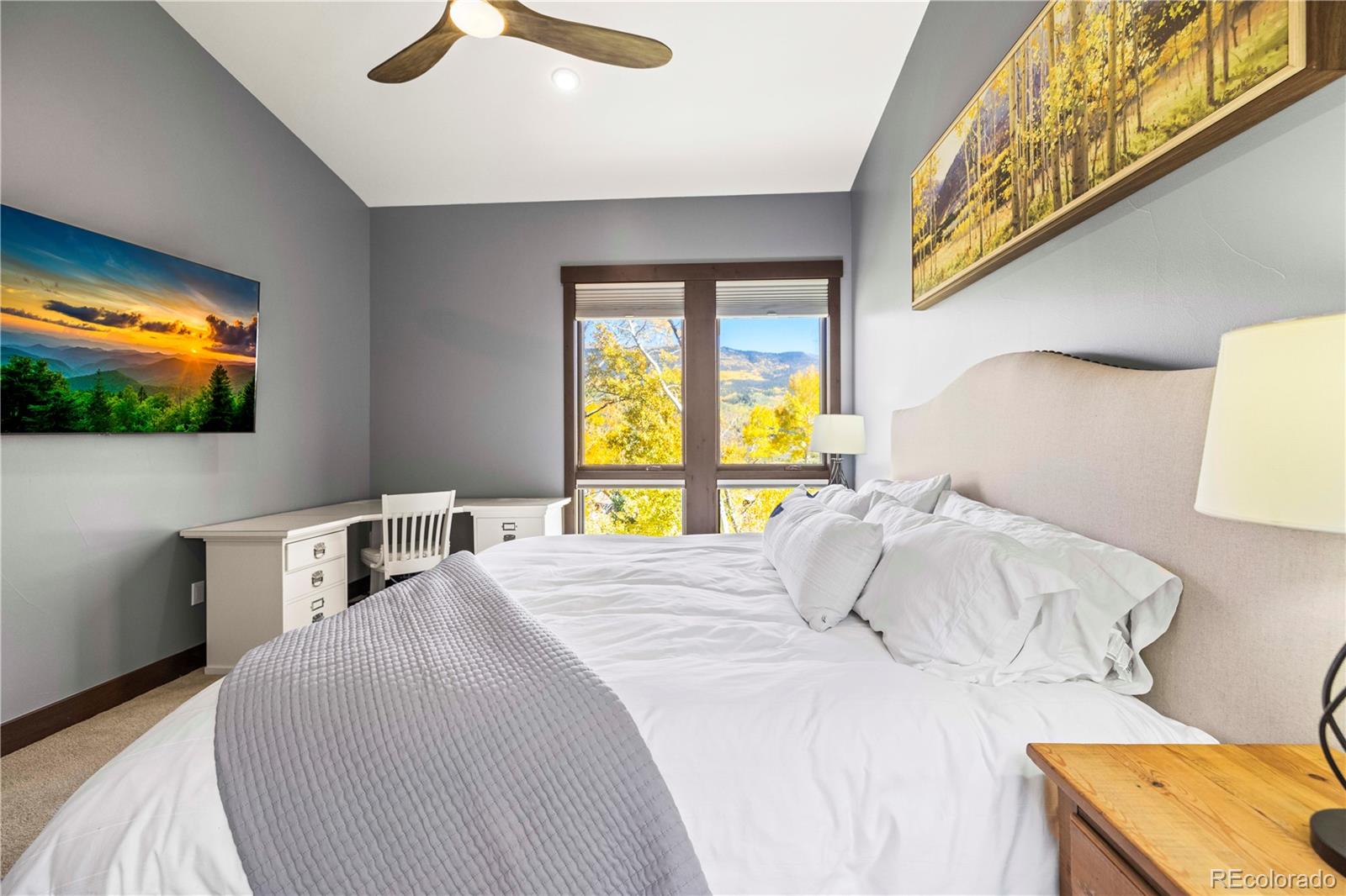 143 Beasley Road Silverthorne, CO 80498 - Photo 17 of 40 a bedroom with a bed and a flat screen tv