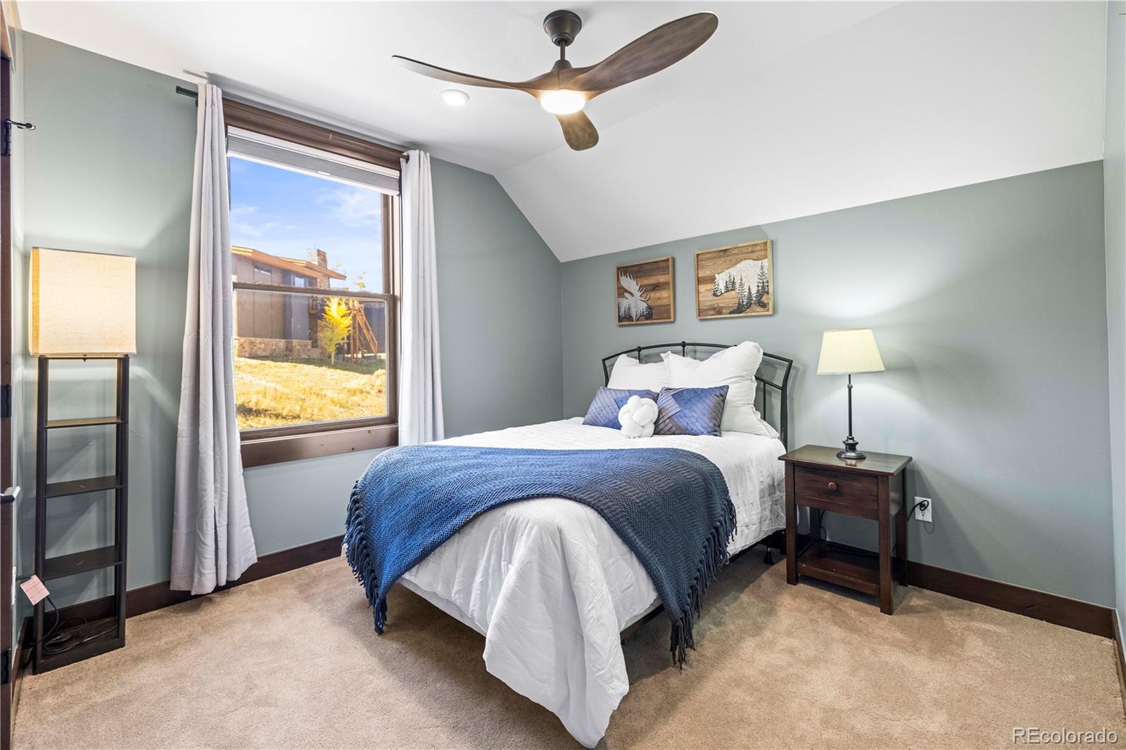 143 Beasley Road Silverthorne, CO 80498 - Photo 25 of 40 a bedroom with a bed and a lamp