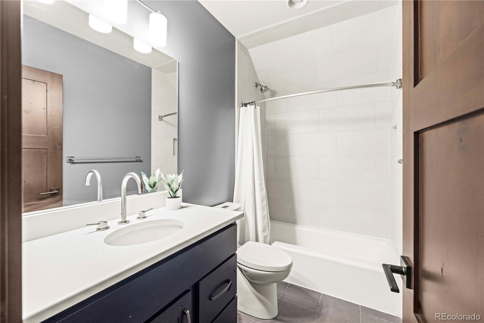 143 Beasley Road Silverthorne, CO 80498 - Photo 27 of 40 a bathroom with a double vanity sink toilet mirror and shower