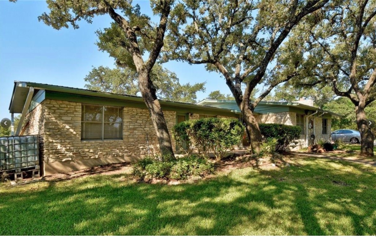 8021 Acton Drive Austin, TX 78736 - Photo 1 of 1 a view of a house with a yard