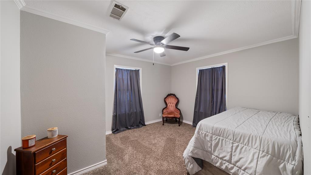 14260 North 3rd Street Scurry, TX 75158 - Photo 11 of 13 Bedroom featuring crown molding, carpet, and ceiling fan