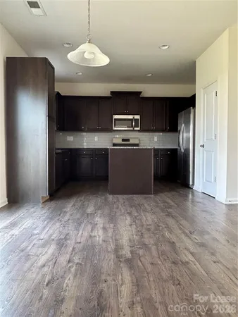 a kitchen with stainless steel appliances wooden cabinets and granite counter tops