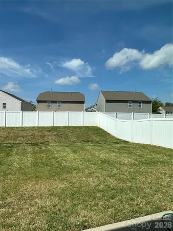 a view of empty room with wooden floor and fireplace