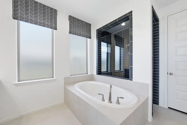 a white bath tub sitting next to a window