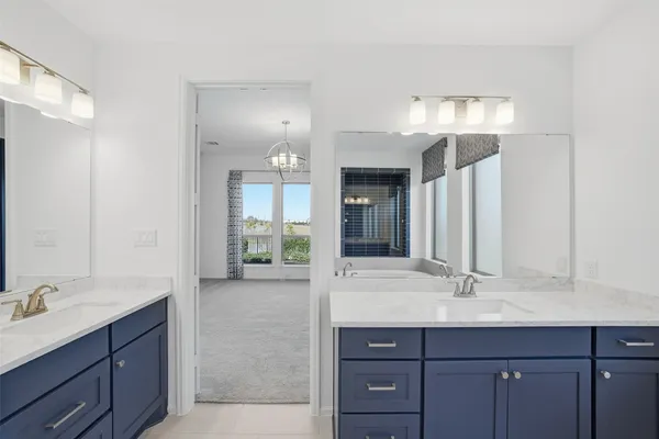a bathroom with a sink double vanity and a mirror