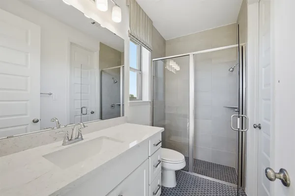 a bathroom with a sink toilet and shower
