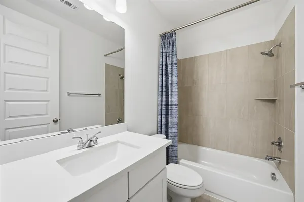 a bathroom with a sink toilet tub and shower