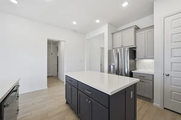 a kitchen with a refrigerator a sink and a refrigerator