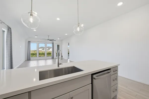 a kitchen with a sink and chandelier