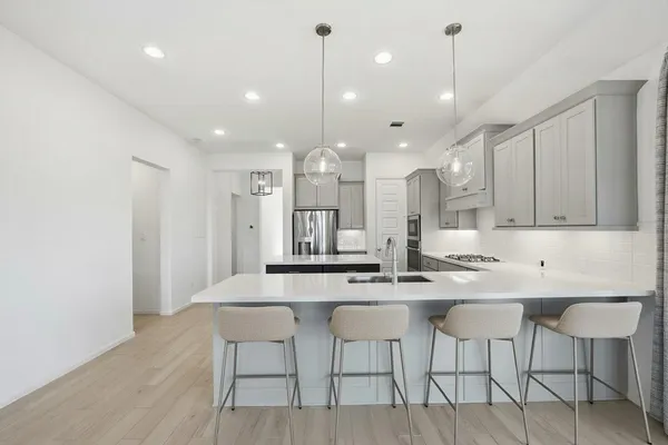 a kitchen with kitchen island granite countertop a table and chairs in it