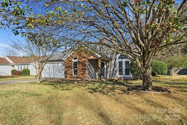 a view of a yard with trees in front of it