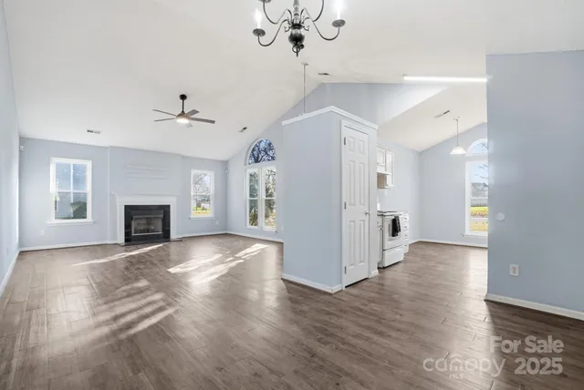 a view of empty room with wooden floor and fireplace
