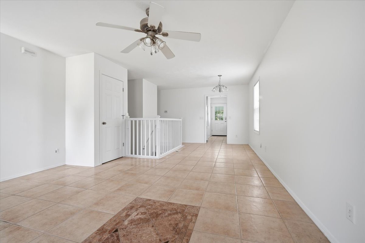 915 Teegan Street Normal, IL 61761 - Photo 5 of 33 a view of a hallway with a chandelier fan and windows