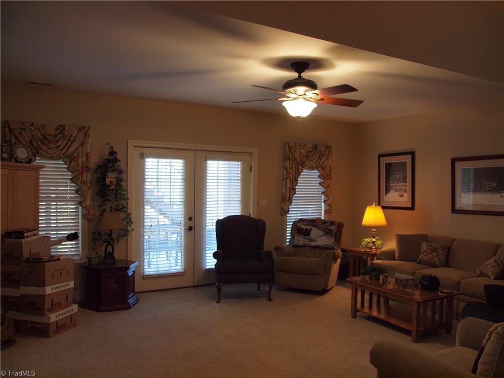 8413 Monticello Ridge Drive Rural Hall, NC 27045 - Photo 17 of 30 downstairs entertainment room, through the french doors is a covered patio