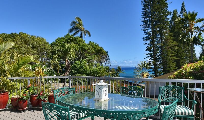 a balcony with wooden floor and fence