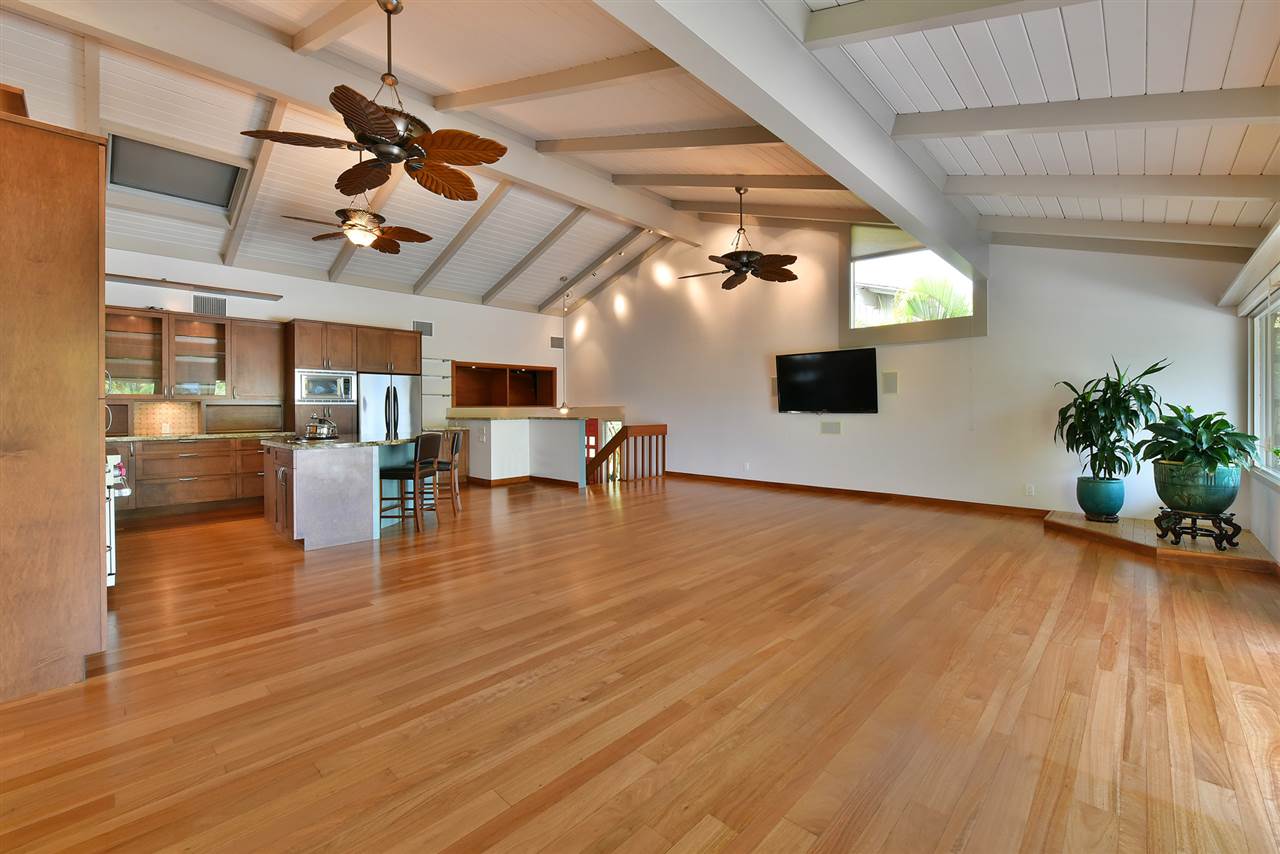 5045 Lower Honoapiilani Road, Unit HOUSE #5 Lahaina, HI 96761 - Photo 12 of 30 a view of a livingroom with furniture wooden floor and a ceiling fan