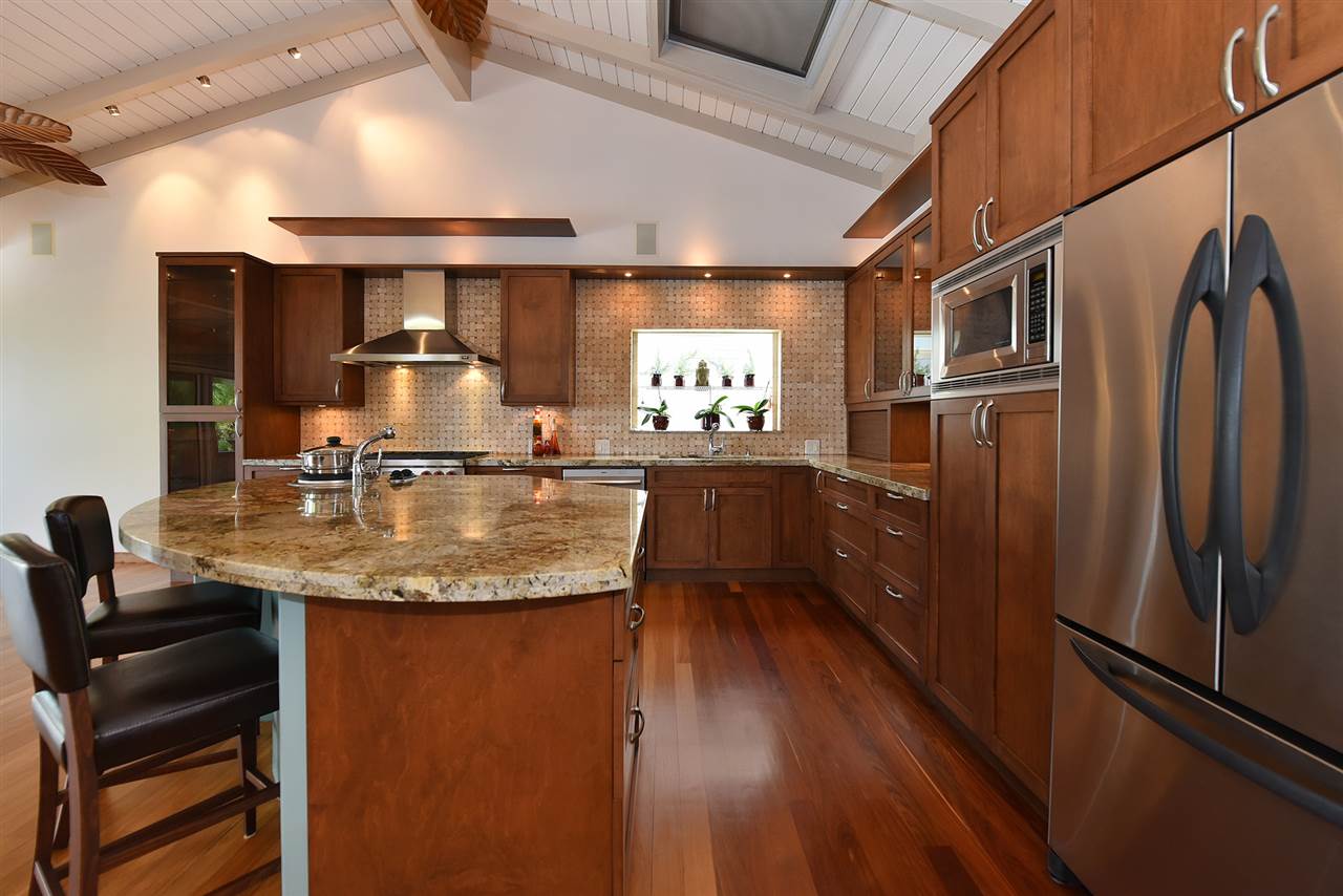 5045 Lower Honoapiilani Road, Unit HOUSE #5 Lahaina, HI 96761 - Photo 13 of 30 a kitchen with stainless steel appliances granite countertop a refrigerator a sink and a stove