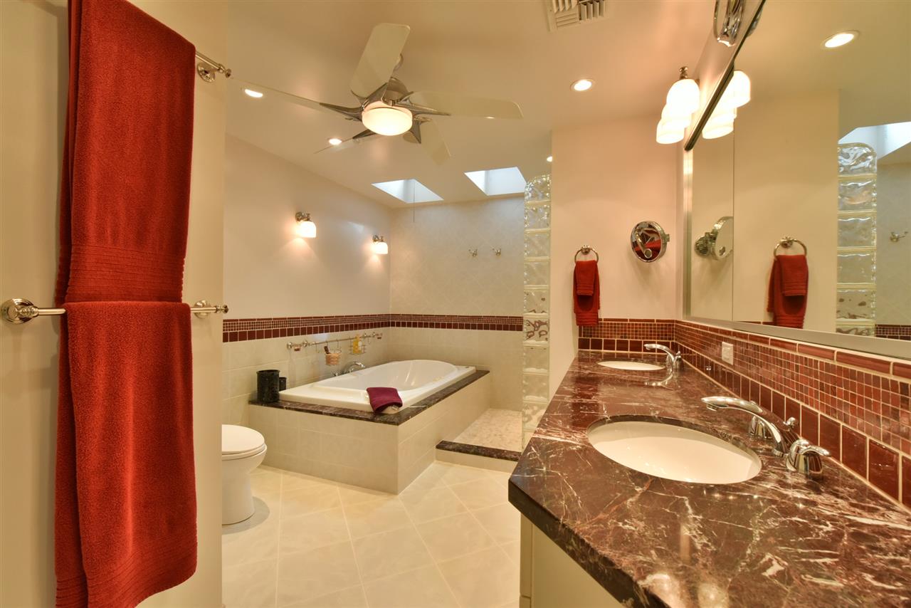 5045 Lower Honoapiilani Road, Unit HOUSE #5 Lahaina, HI 96761 - Photo 19 of 30 a bathroom with a granite countertop sink and a mirror