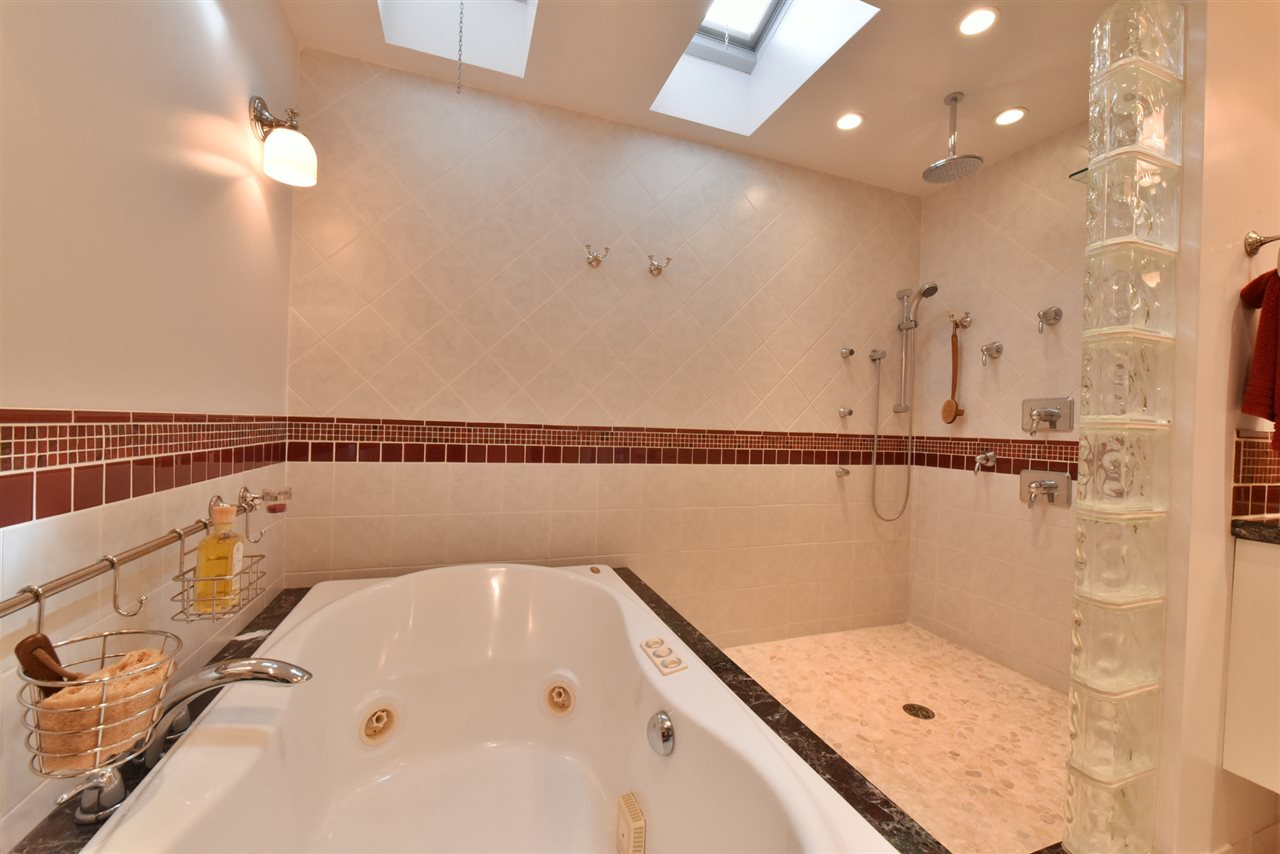 5045 Lower Honoapiilani Road, Unit HOUSE #5 Lahaina, HI 96761 - Photo 20 of 30 a bathroom with a tub and a shower