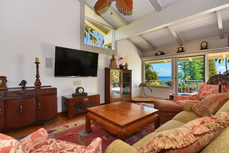 5045 Lower Honoapiilani Road, Unit HOUSE #5 Lahaina, HI 96761 - Photo 4 of 30 a living room with furniture a flat screen tv and a floor to ceiling window