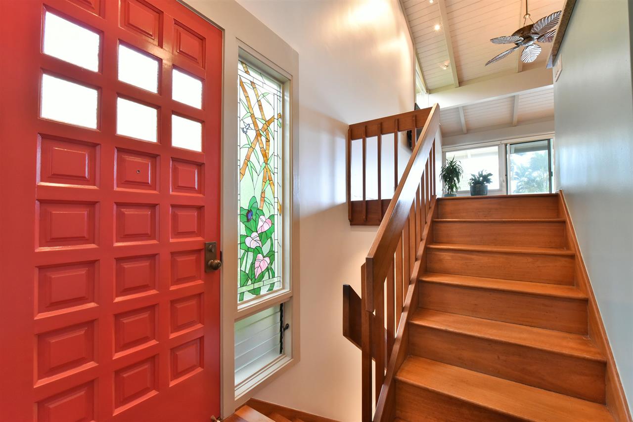 5045 Lower Honoapiilani Road, Unit HOUSE #5 Lahaina, HI 96761 - Photo 8 of 30 a view of staircase with lots of frames on wall and a window