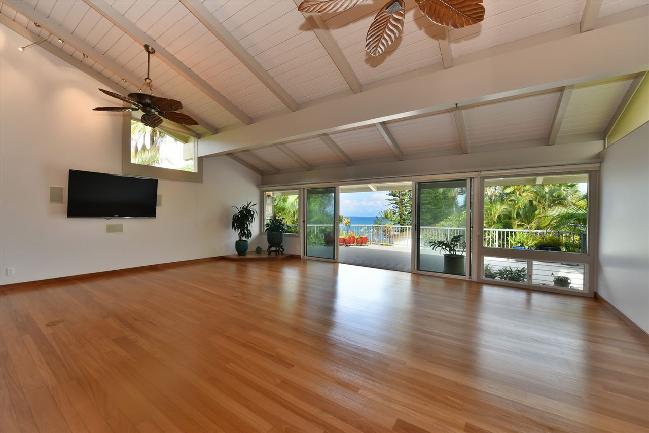 5045 Lower Honoapiilani Road, Unit HOUSE #5 Lahaina, HI 96761 - Photo 10 of 30 a view of a livingroom with furniture wooden floor and windows