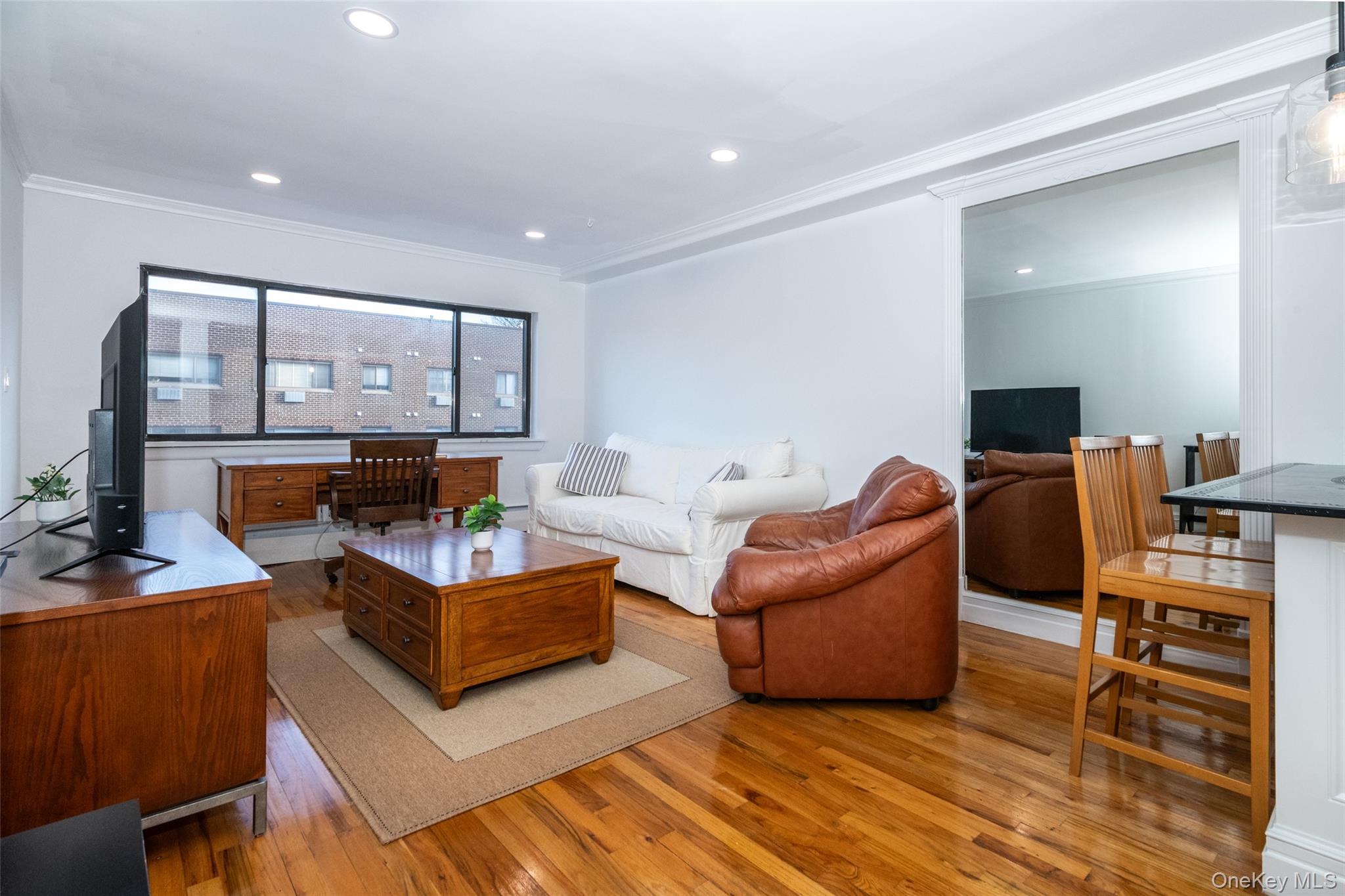 2221 Palmer Avenue, Unit 3D New Rochelle, NY 10801 - Photo 1 of 18 a living room with furniture and a flat screen tv